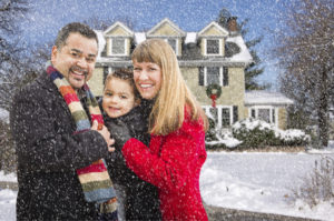 Happy Mixed Race Young Family in Front of Beautiful Snow Covered